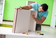 Man repairing furniture at home [IBR125094394]