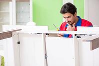 Repair contractor repairing broken furniture at home [IBR125094396]