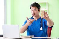 Young doctor working in the hospital [IBR125094397]