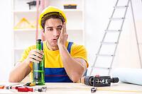 Drunk engineer working in the workshop [IBR125094402]
