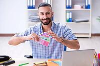 Young designer working in his studio on new project [IBR125094422]