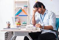 Young handsome male designer working in the office [IBR125117996]