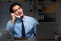 Young male architect working night at office [IBR125117998]