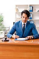Young handsome judge sitting in courtroom [IBR125118016]