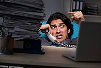 Young male employee working late at office [IBR125118017]