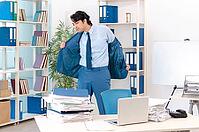 Young handsome male employee with too much work in the office [IBR125118018]
