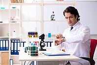 Young handsome chemist working in the lab [IBR125118029]
