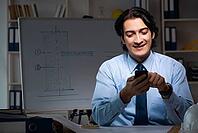 Young male architect working night at office [IBR125118030]
