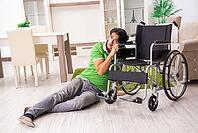 Young handsome man in wheelchair at home [IBR125118034]