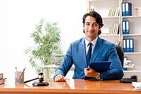 Young handsome judge sitting in courtroom [IBR125118042]