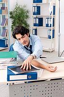 Young male employee in blood transfusion concept [IBR125118045]
