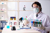 Young handsome chemist working in the lab [IBR125118052]