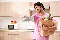 Young handsome man with vegetables in the kitchen [IBR125118055]