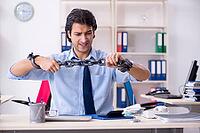 Young male businessman employee unhappy with excessive work [IBR125141678]