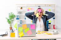 Young female employee in conflicting priorities concept [IBR125141713]