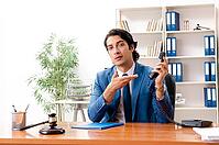 Young handsome judge sitting in courtroom [IBR125141724]