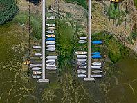Drought on Lake Constance. The marina of Mannenbach-Salenstein in the canton of Thurgau is almost completely dry. Boats are dry at the dock and can no longer get into the water. aerial view. Mannenbach-Salenstein, Canton of Thurgau, Switzerland [IBR125163337]