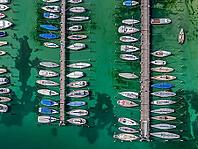 Marina of the Yacht Club Insel Reichenau. The lake bed can be seen in many shallow water zones. The water level of Lake Constance is currently low for the time of year. Reichenau, Baden-Württemberg, Germany [IBR125163343]