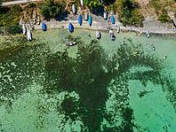 Lake Constance shore on the island of Reichenau with boats and swimmers. The bottom of the lake can be seen in many shallow water zones. The water level of Lake Constance is currently low for the time of year. Reichenau, Baden-Württemberg, Germany [IBR125163349]