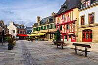 The old town and fortified Ville Close of Concarneau occupy a walled island in the Bay of Concarneau, Finistère, Brittany, France. Stone ramparts, towers, harbour buildings and surrounding water are visible in natural daylight, with the town opening towar [IBR125163361]