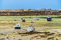 The rocky coast and small harbour of Île Vierge lie off Plouguerneau in Finistère, Brittany, France. Granite rocks, sheltered waters and moored boats form a characteristic maritime landscape along this exposed section of the northern Breton coast [IBR125163371]