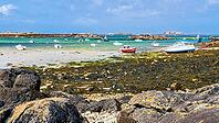 The rocky coast and small harbour of Île Vierge lie off Plouguerneau in Finistère, Brittany, France. Granite rocks, sheltered waters and moored boats form a characteristic maritime landscape along this exposed section of the northern Breton coast [IBR125163374]