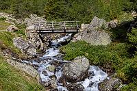 Wooden bridge over mountain stream, Torrente di Val Campaccio, climb to Lake Campaccio, Monte, Valdisotto, Sondrio, Italy [IBR125163423]