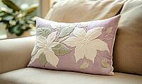 Soft lavender pillow with white poinsettia embroidery and hints of soft green. AI generated [IBR125167394]