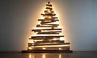 Minimalist Christmas tree silhouette made from natural wooden planks against a white wall. AI generated [IBR125167431]