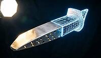 Aerospace turbine blade bisected vertically at chord midpoint, left half rendered as polished nickel superalloy physical component, right half as glowing blue-white CAD wireframe mesh, digital twin and smart manufacturing concept, dark background, studio  [IBR125167450]