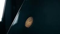 Latent fingerprint friction ridge detail revealed by raking sidelight on dark glass surface, amber luminous ridge lines against teal-black background, forensic crime scene investigation concept, studio shot, AI generated [IBR125167457]
