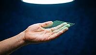Human hand open palm floating against dark navy background, contactless biometric fingerprint scanning laser grid projected above fingertips, next-generation fingerprint capture technology concept, studio shot, AI generated [IBR125167461]