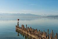 Wooden walkways on Lake Constance with a view of the Alps, moated castle, Bavaria, Germany [IBR125173446]