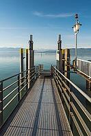 Metal footbridge with view of the Alps, moated castle am Lake Constance, Bavaria, Germany [IBR125173453]