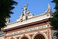 Building facade, sculpture, angel, statue, architectural detail, decorated, stone relief, blue sky, Teatro Arena del Sole, Bologna, Emilia-Romagna, Italy [IBR125177935]