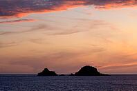 Sunset, sunset at sea, dramatic clouds, in the background rock formation The Brisons, Cot Valley Beach, Porth Nanven, coast, St Just in Penwith, Cornwall, England, Great Britain, Great Britain [IBR125177961]