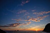 Sunset, sunset at sea, dramatic clouds, in the background rock formation The Brisons, Cot Valley Beach, Porth Nanven, coast, St Just in Penwith, Cornwall, England, Great Britain, Great Britain [IBR125177969]