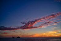 Sunset, sunset at sea, dramatic clouds, in the background rock formation The Brisons, Cot Valley Beach, Porth Nanven, coast, St Just in Penwith, Cornwall, England, Great Britain, Great Britain [IBR125177971]