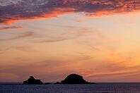 Sunset, sunset at sea, dramatic clouds, in the background rock formation The Brisons, Cot Valley Beach, Porth Nanven, coast, St Just in Penwith, Cornwall, England, Great Britain, Great Britain [IBR125177984]