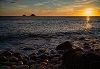 Evening, sunset at sea, in the background rock formation The Brisons, Cot Valley Beach, Porth Nanven, also beach of dinosaur eggs, coast, St Just in Penwith, Cornwall, England, Great Britain, Great Britain [IBR125177991]