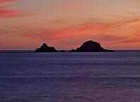 Sunset, sunset at sea, dramatic clouds, in the background rock formation The Brisons, Cot Valley Beach, Porth Nanven, coast, St Just in Penwith, Cornwall, England, Great Britain, Great Britain [IBR125177993]