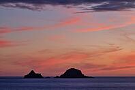 Sunset, sunset at sea, dramatic clouds, in the background rock formation The Brisons, Cot Valley Beach, Porth Nanven, coast, St Just in Penwith, Cornwall, England, Great Britain, Great Britain [IBR125177994]