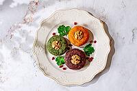 Assortment of Phali, three types, pumpkin, spinach and beetroot, on a round plate, Georgian dish, appetizer with nuts and spices, no people, homemade [IBR125178022]