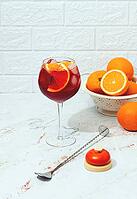 Making an Aperol cocktail, with a colander of oranges in the background, a bottle of Aperol, a cocktail spoon, and a bartender's bell, there are no people [IBR125178023]