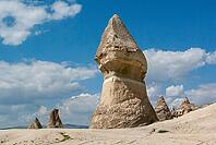 Scenic Cappadocia valley in Turkey featuring fairy chimneys, soft sunlight, rugged formations, and greenery in Turkey [IBR125180367]