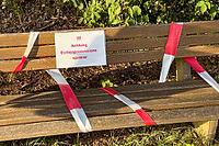 Park bench in the sun, blocked with barrier tape and sign oak procession spinner, Guxhagen, Hesse, Germany [IBR125180386]