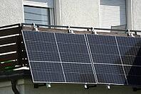A large balcony power plant is mounted on the balcony cladding. The Sun is Shining on the Solar Modules That Are Mounted at an Angle [IBR125185842]