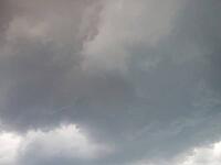 Dense grey cloud cover that radiates a stormy atmosphere, heavy cloudiness in the sky in 27798 Hude, Germany [IBR125185867]