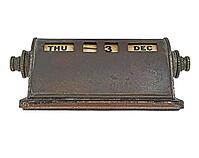 Vintage rusty brass perpetual calendar over white [IBR125188162]