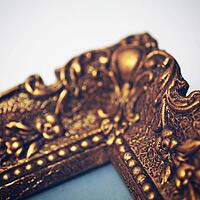 Detail of an antik gold picture frame [IBR125188199]